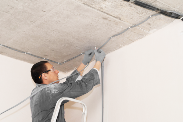 man fixing electrical wiring